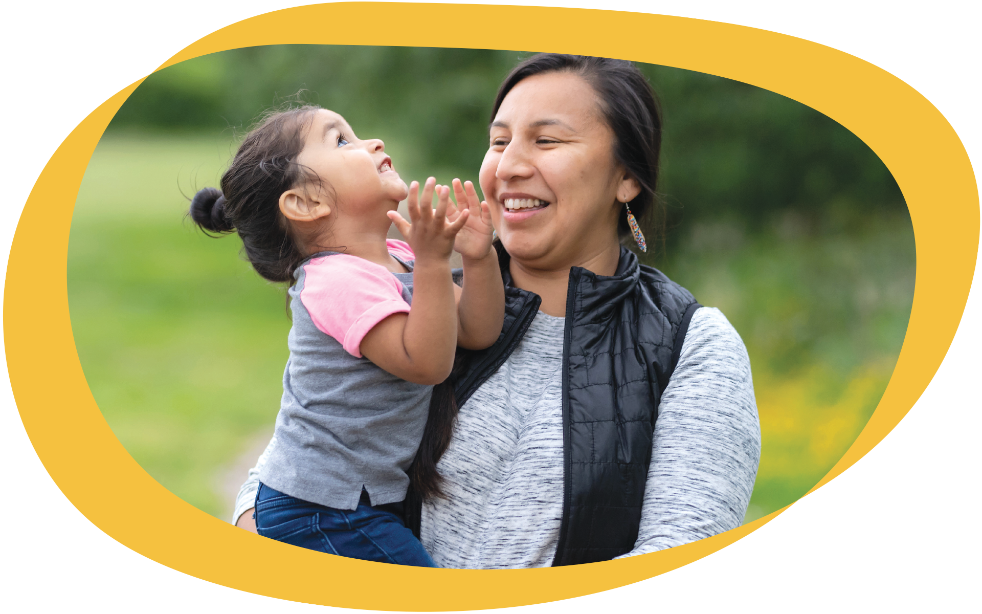 Mother holding her child, laughing together